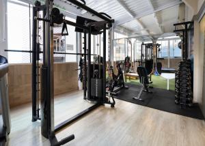 a gym with several treadmills and exercise equipment at Camboriú Praia Hotel in Balneário Camboriú +87 photos