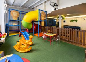 a childrens play area with a slide and a playground at Camboriú Praia Hotel in Balneário Camboriú