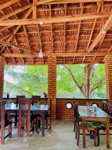 a dining room with tables and chairs and a wooden ceiling at FA Resort in Panama