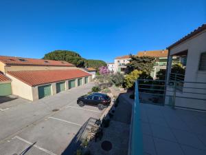 a car parked in a parking lot next to a building at T2 Château vert in Le Grau-dʼAgde