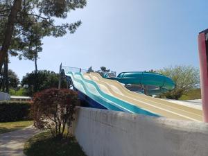 a slide in a park with a water slide at Le ptit Galet 462 in La Tremblade