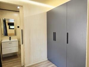 a bathroom with a white cabinet and a mirror at Camping Costa Dorada Tiny Amaia in Canet de Mar