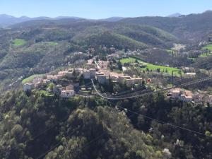 an aerial view of a city with a suspension bridge over a city at House la Ginestra in Sellano