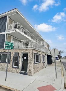 a building on a street with a street sign at Sunset Beach Hotel in Wildwood