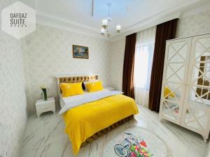 a bedroom with a yellow bed with a yellow blanket at Qafqaz mountain villa in Mekhrably