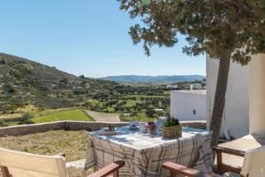 a table and chairs on a patio with a view at Vira Señor House in Triovasálos