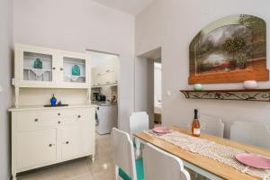 a kitchen and dining room with a table and chairs at Vira Señor House in Triovasálos +11 photos