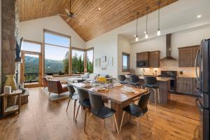 a kitchen and living room with a table and chairs at Lakota Villa 607 Next to WP Resort I Private Hot Tub I Amazing Views I Activity Program in Winter Park