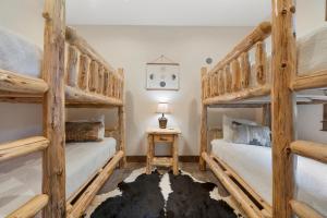 two sets of bunk beds in a bedroom at Lakota Villa 607 Next to WP Resort I Private Hot Tub I Amazing Views I Activity Program in Winter Park