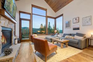 a living room with a couch and a fireplace at Lakota Villa 607 Next to WP Resort I Private Hot Tub I Amazing Views I Activity Program in Winter Park