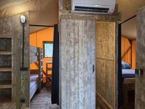 an open door to a room with a bedroom and bunk beds at Camping Costa Dorada Tienda Lua in Canet de Mar