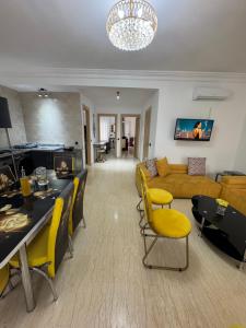 a living room with yellow chairs and a couch at Appartement de luxe à Tanger Maroc in Tangier