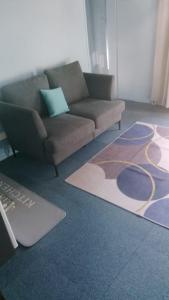 a living room with a couch and a rug at Relais de Bénévent in Bénévent-lʼAbbaye