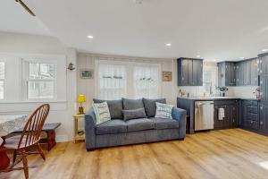 a living room with a couch and a kitchen at Cool Change in Hampton