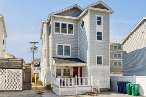 a large white house with a red door at Cool Change in Hampton