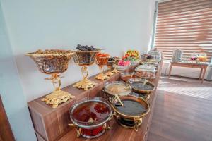a table with many bowls and vases on it at Hotel Danzha2 Erbil in Erbil