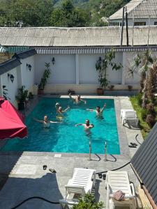 a group of people swimming in a swimming pool at Qafqaz mountain villa in Mekhrably