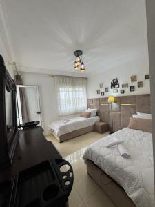 a large bedroom with two beds and a mirror at Appartement de luxe à Tanger Maroc in Tangier +21 photos