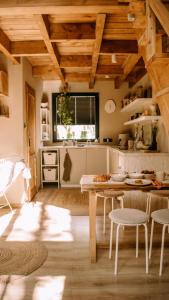 a kitchen with wooden ceilings and a table and chairs at Domek SzumiSosna2 in Życiny