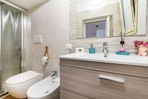 a bathroom with a sink and a toilet and a mirror at La casetta di pami- Enjoy Apulia in Monopoli