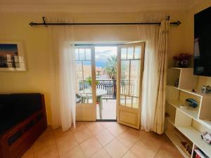a living room with a door open to a patio at 2 bed appartment, close to the beach in Albufeira