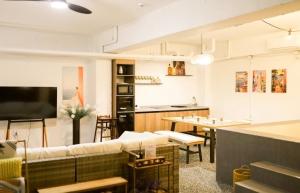 a living room with a couch and a table at Radiance Stay in Paengnodam