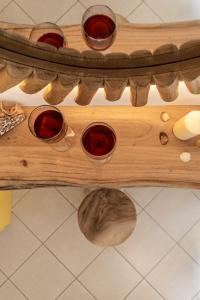 a wooden shelf with four glasses of red wine at Sunshine in Naxos Chora