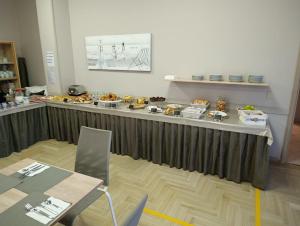 a buffet of food on a table in a room at Hotel Furga B&B in Cervia