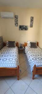 two beds sitting next to each other in a room at Villa Carma in Kos +15 photos