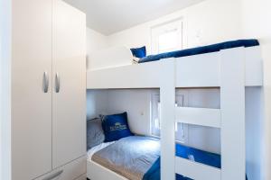 a bedroom with two bunk beds with blue pillows at Floating House Royal Blue Portorož in Portorož