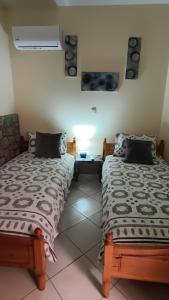 two beds sitting next to each other in a room at Villa Carma in Kos