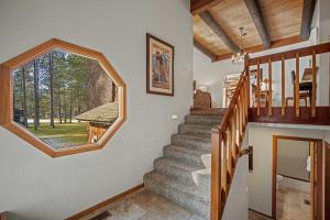 a staircase in a house with a large window at 61 Wildflower in Sunriver
