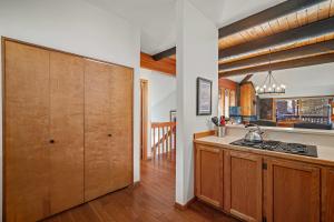 a kitchen with wooden cabinets and a counter top at 61 Wildflower in Sunriver +26 photos
