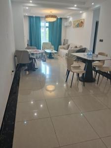a living room with tables and chairs and a couch at 海客瀛洲 Haïke-Îlezone in Abidjan