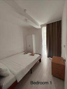 a bedroom with a bed and a dresser in it at Luna duplex Apartment in Star Dojran