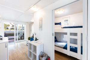 a small bedroom with bunk beds and a bathroom at Floating House Royal Blue Portorož in Portorož