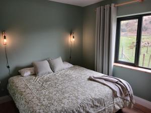 a bedroom with a bed and a window at Mountain hideaway in Finny