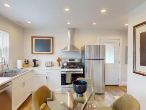 a kitchen with a stainless steel refrigerator and a table at The Nook on Landess in Marion +10 photos
