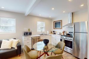 a kitchen with a glass table and a stainless steel refrigerator at The Nook on Landess in Marion
