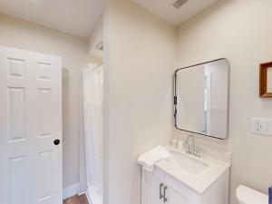 a white bathroom with a sink and a mirror at The Nook on Landess in Marion
