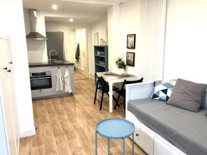 a small living room with a couch and a table at Le Petit Ekrin des Ursines in Vélizy-Villacoublay +4 photos