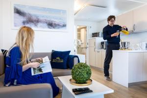 a man standing in a kitchen talking to a woman at Floating House Royal Blue Portorož in Portorož +12 photos