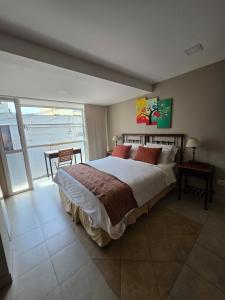 a bedroom with a large bed and a balcony at Caseros Centro Salta in Salta +83 photos