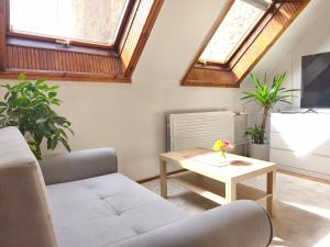 a living room with a couch and a table at Prime Location Apartment Vilnius in Vilnius