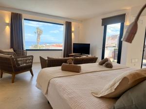 a bedroom with two beds and a living room with a view at Ocean Suite by SHC with heated pool only for adults in Telde +70 photos