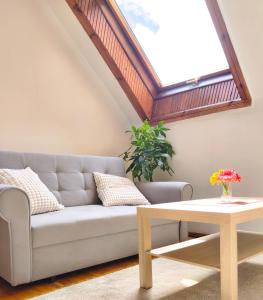 a living room with a couch and a table at Prime Location Apartment Vilnius in Vilnius