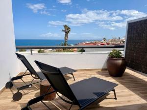 a balcony with chairs and a view of the ocean at Ocean Suite by SHC with heated pool only for adults in Telde