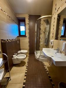 a bathroom with two toilets and a sink and a shower at Pensjonat Klimek in Muszyna +52 photos