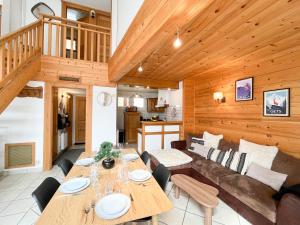 a living room with a table and a couch at Duplex Les Gets Centre Local VTT Sécurisé & Balcon 6P in Les Gets +44 photos