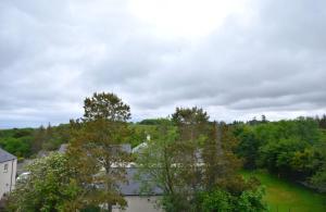 an overhead view of a city with trees and buildings at Cozy 1 bed flat in Stornoway in Stornoway